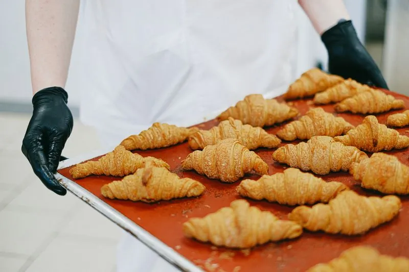 Baked croissants on a red tray